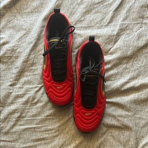 Red Nike Sneakers with Black and Gold Accents